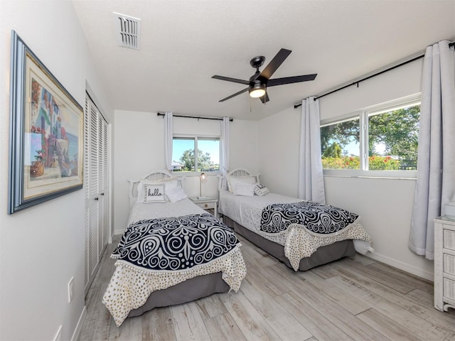 1232 Pine Needle Rd, Venice, FL 34285 - bedroom featuring a closet, baseboards, visible vents, multiple windows, and light wood finished floors