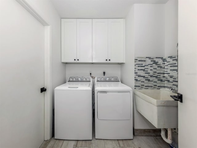 1232 Pine Needle Rd, Venice, FL 34285 - laundry room featuring cabinet space, washer and clothes dryer, and a sink
