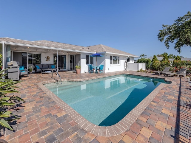 1232 Pine Needle Rd, Venice, FL 34285 - view of pool with an outdoor living space, grilling area, a patio area, fence, and a fenced in pool
