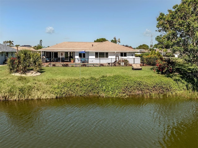1232 Pine Needle Rd, Venice, FL 34285 - rear view of house with a lawn, a fenced backyard, a patio area, and a water view