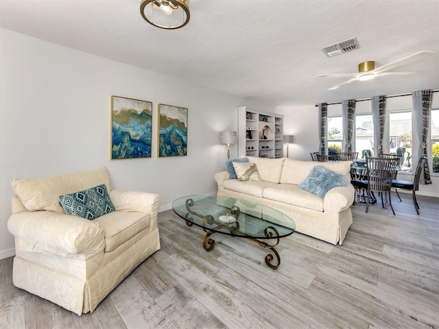 1232 Pine Needle Rd, Venice, FL 34285 - living room with wood finished floors, ceiling fan, baseboards, and visible vents