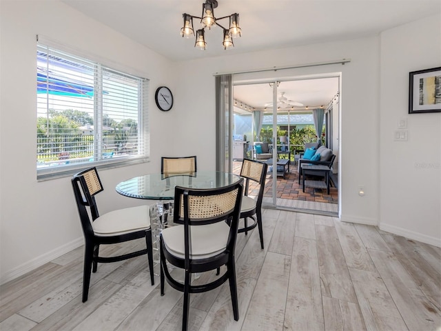 1232 Pine Needle Rd, Venice, FL 34285 - dining space featuring light wood-style flooring, an inviting chandelier, and baseboards