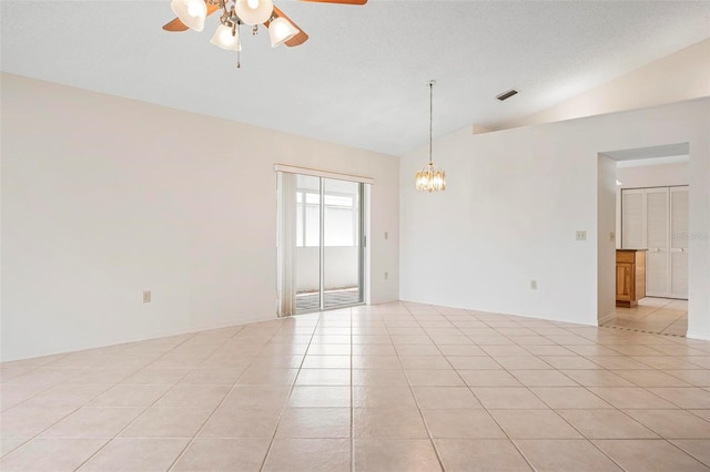 799 Harrington Lake Dr N Unit 73, Venice, FL 34293 - unfurnished room with light tile patterned floors, visible vents, ceiling fan with notable chandelier, and vaulted ceiling