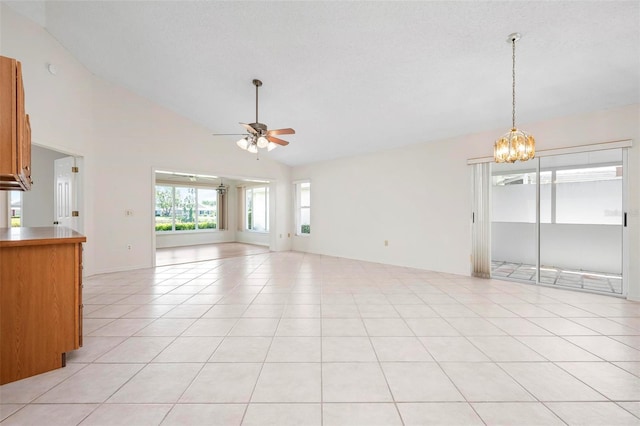 799 Harrington Lake Dr N Unit 73, Venice, FL 34293 - spare room with light tile patterned floors, ceiling fan with notable chandelier, and lofted ceiling