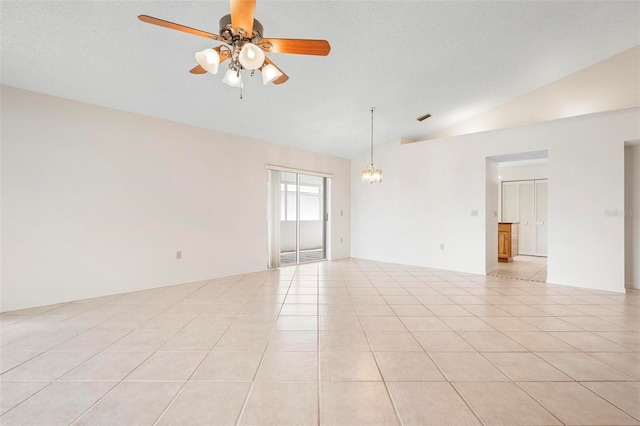 799 Harrington Lake Dr N Unit 73, Venice, FL 34293 - empty room with visible vents, light tile patterned floors, vaulted ceiling, and ceiling fan with notable chandelier