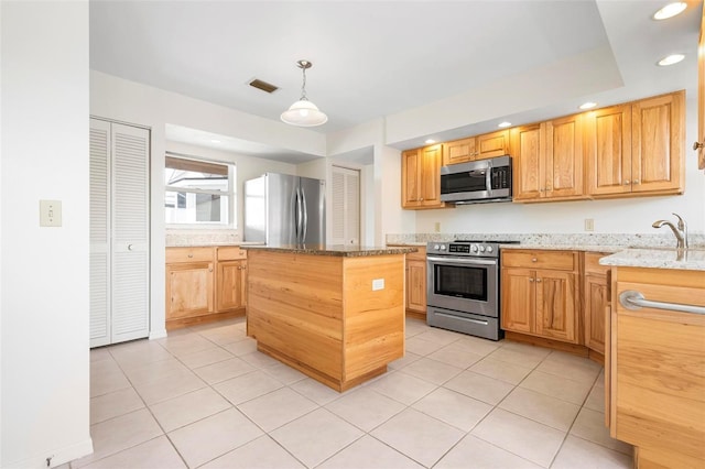 799 Harrington Lake Dr N Unit 73, Venice, FL 34293 - kitchen featuring light stone countertops, appliances with stainless steel finishes, light tile patterned floors, and visible vents