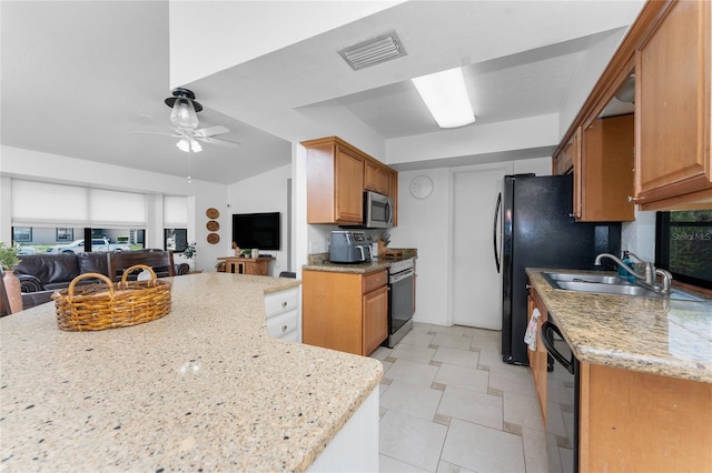 kitchen with light stone countertops, a ceiling fan, visible vents, appliances with stainless steel finishes, and open floor plan