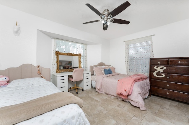 bedroom with stone finish floor and a ceiling fan