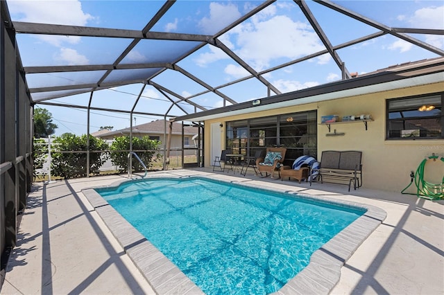 outdoor pool featuring a lanai and a patio area