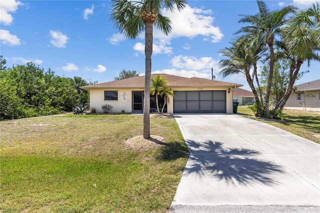 ranch-style house with concrete driveway, a front yard, stucco siding, and an attached garage