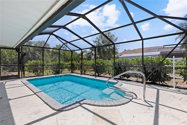 outdoor pool featuring glass enclosure and a patio