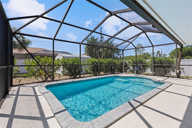 outdoor pool featuring a patio area and a lanai