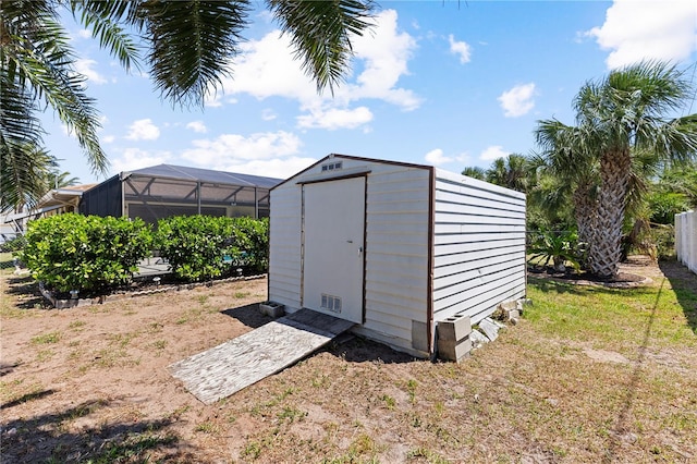 view of shed featuring fence