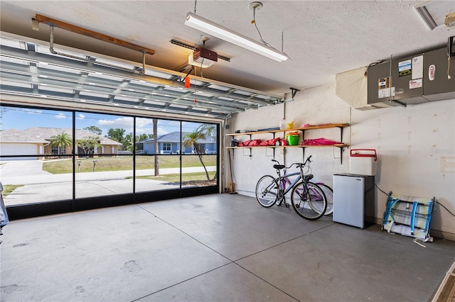 garage featuring refrigerator and a garage door opener