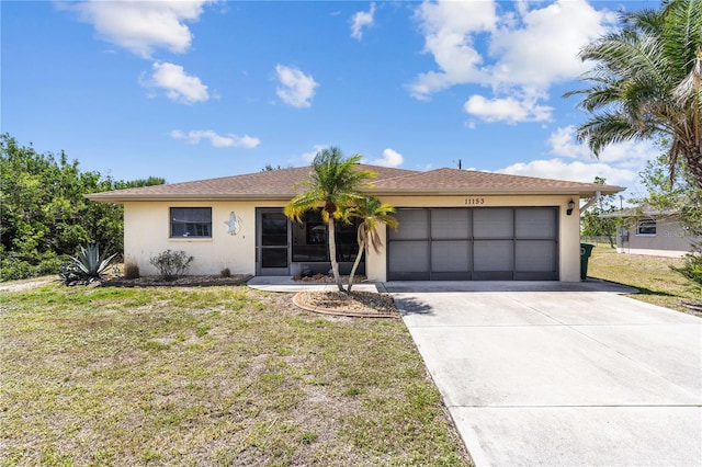 ranch-style house with a front yard, an attached garage, driveway, and stucco siding