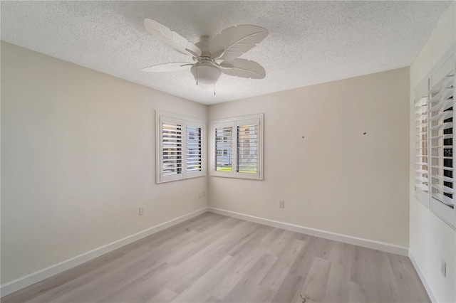 700 Golden Beach Blvd Unit 115, Venice, FL 34285 - unfurnished room featuring light wood-style flooring, a textured ceiling, ceiling fan, and baseboards