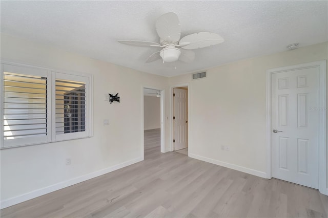 700 Golden Beach Blvd Unit 115, Venice, FL 34285 - spare room with light wood-style flooring, a textured ceiling, baseboards, and ceiling fan