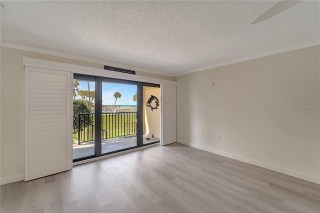 700 Golden Beach Blvd Unit 115, Venice, FL 34285 - unfurnished room featuring a textured ceiling, wood finished floors, ornamental molding, and baseboards