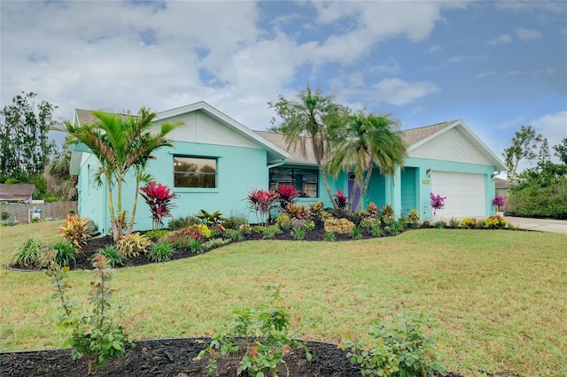 990 Sea Fox Rd, Venice, FL 34293 - single story home with stucco siding, a front yard, fence, a garage, and driveway
