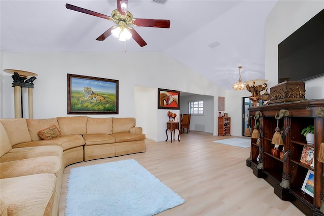 990 Sea Fox Rd, Venice, FL 34293 - living room with light wood-style flooring, ceiling fan with notable chandelier, visible vents, and lofted ceiling