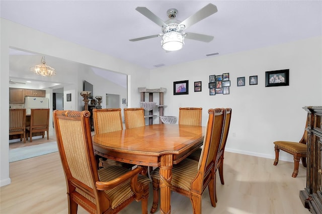 990 Sea Fox Rd, Venice, FL 34293 - dining area with light wood-style flooring, ceiling fan with notable chandelier, baseboards, and visible vents