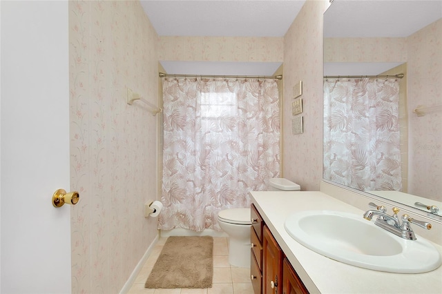 990 Sea Fox Rd, Venice, FL 34293 - full bath with vanity, toilet, tile patterned floors, wallpapered walls, and baseboards