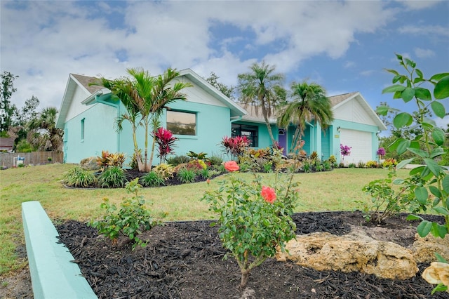 990 Sea Fox Rd, Venice, FL 34293 - ranch-style home featuring a garage, a front yard, fence, and stucco siding