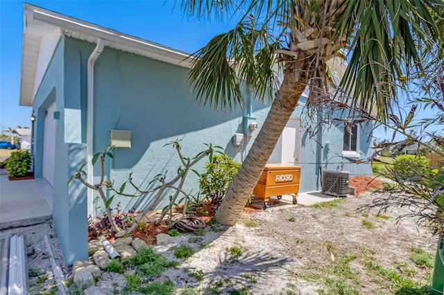 view of home's exterior featuring central AC unit and stucco siding