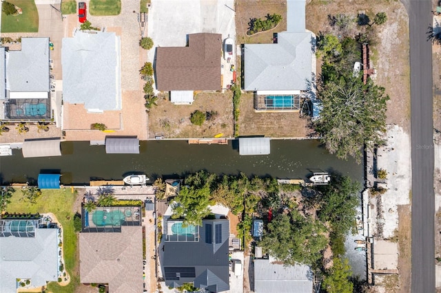 drone / aerial view with a residential view and a water view
