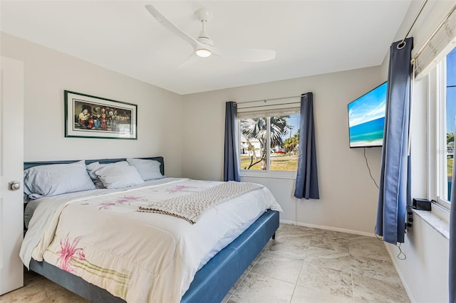 bedroom with baseboards and a ceiling fan