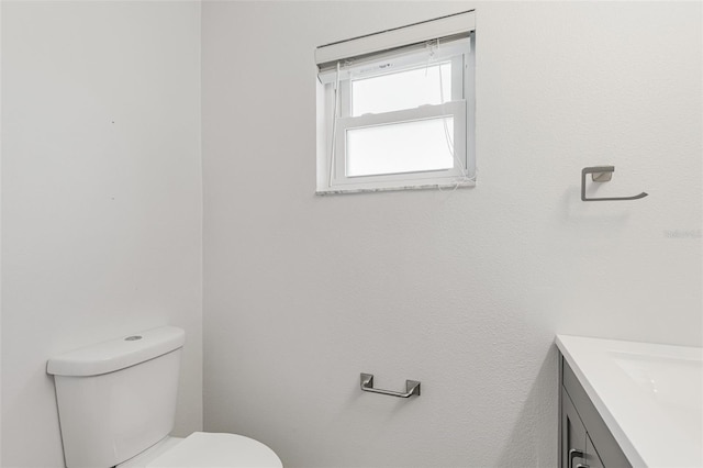 half bathroom featuring toilet and vanity
