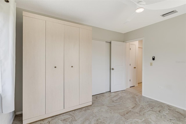 unfurnished bedroom with visible vents, baseboards, marble finish floor, and a closet
