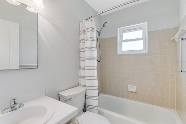bathroom with shower / tub combo, toilet, and vanity