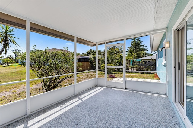 unfurnished sunroom featuring a wealth of natural light