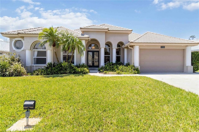 201 Bayside Ct, Nokomis, FL 34275 - mediterranean / spanish-style home featuring stucco siding, a front lawn, french doors, and a garage