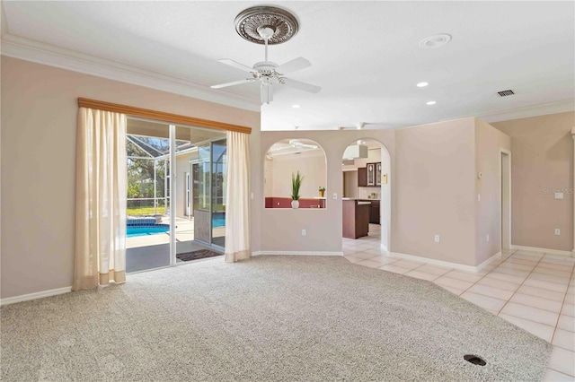 201 Bayside Ct, Nokomis, FL 34275 - unfurnished living room with a ceiling fan, arched walkways, baseboards, ornamental molding, and visible vents
