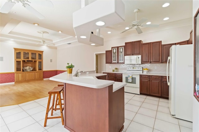 201 Bayside Ct, Nokomis, FL 34275 - kitchen with ceiling fan, ornamental molding, white appliances, and a raised ceiling