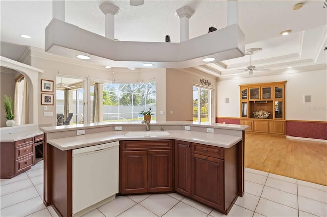 201 Bayside Ct, Nokomis, FL 34275 - kitchen featuring a tray ceiling, a sink, open floor plan, a ceiling fan, and dishwasher