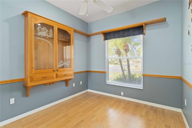201 Bayside Ct, Nokomis, FL 34275 - empty room featuring baseboards, a ceiling fan, and wood finished floors