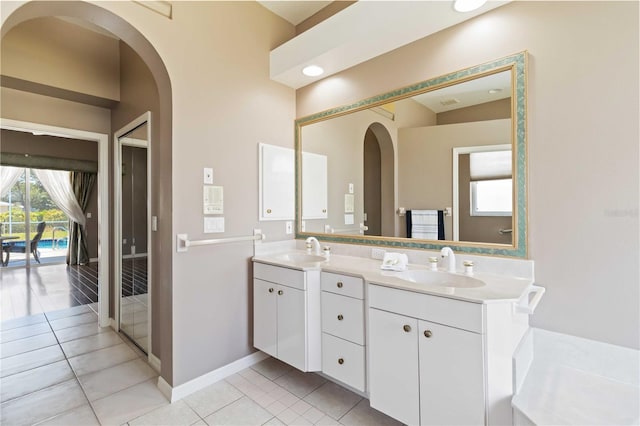 201 Bayside Ct, Nokomis, FL 34275 - full bath with tile patterned floors, baseboards, a sink, and double vanity