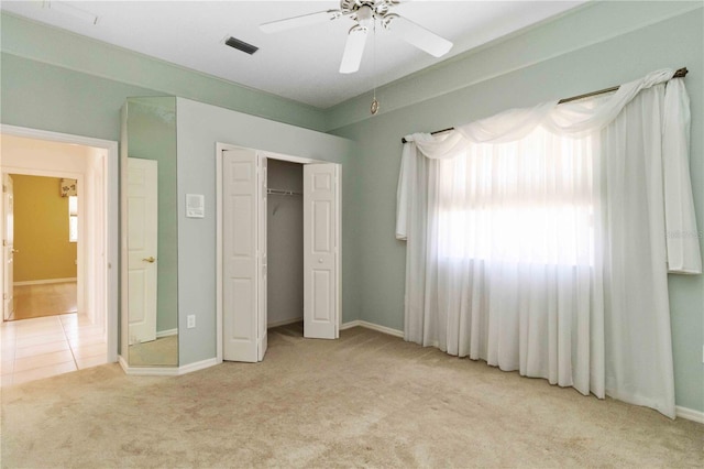201 Bayside Ct, Nokomis, FL 34275 - unfurnished bedroom with a closet, ceiling fan, light carpet, baseboards, and visible vents