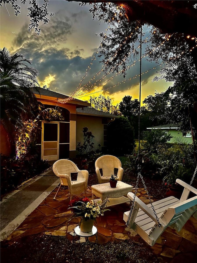 view of patio terrace at dusk