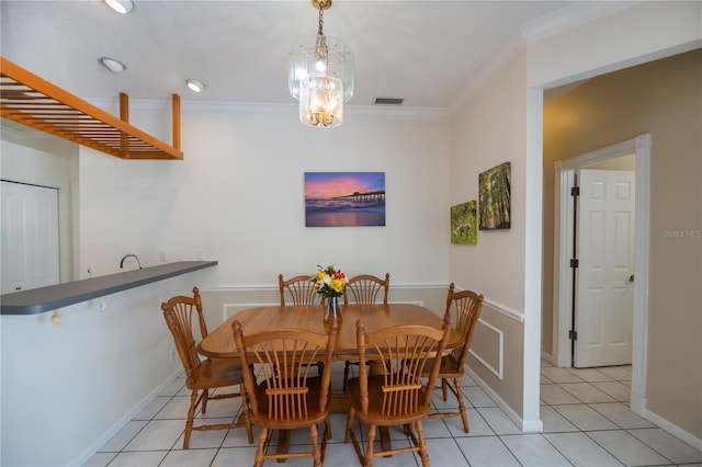 dining area with light tile patterned flooring, baseboards, visible vents, and ornamental molding