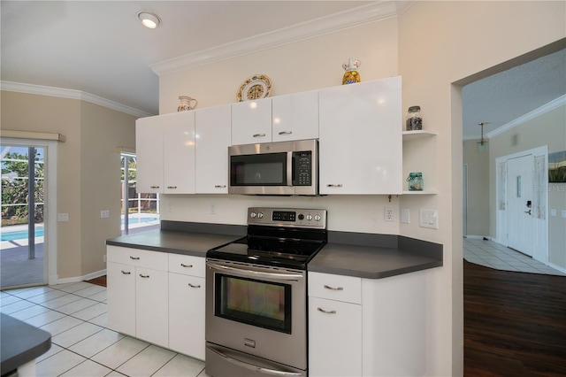 kitchen with ornamental molding, open shelves, dark countertops, and stainless steel appliances