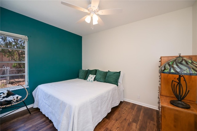 bedroom with baseboards, ceiling fan, and wood finished floors