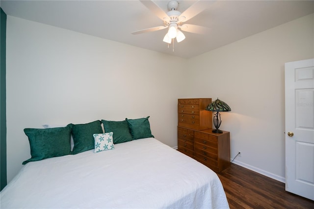 bedroom with baseboards, ceiling fan, and wood finished floors
