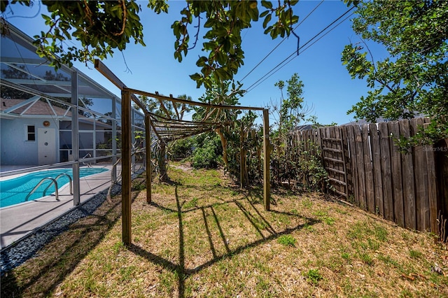view of yard featuring a fenced backyard, a fenced in pool, a lanai, and a patio