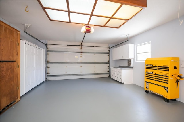 garage featuring heating unit and a garage door opener