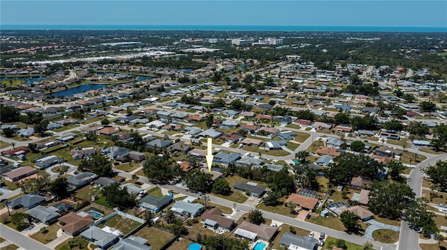 drone / aerial view featuring a residential view and a water view