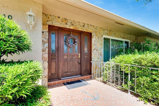 810 Anchorage Ln, Palm Harbor, FL 34685 - property entrance with stone siding and stucco siding